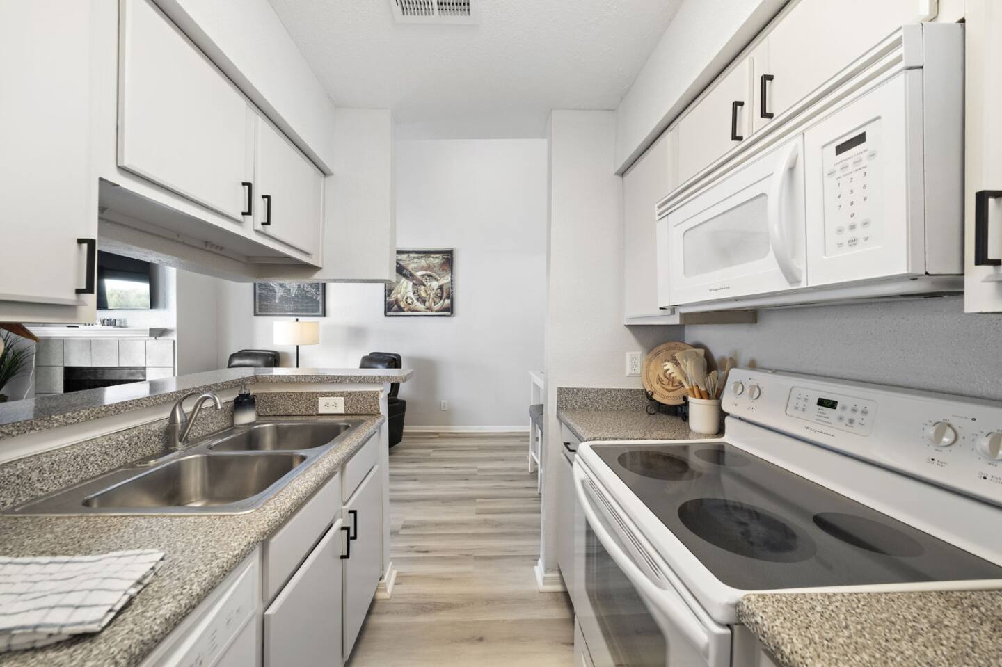 Sleek kitchen with granite counters & appliances