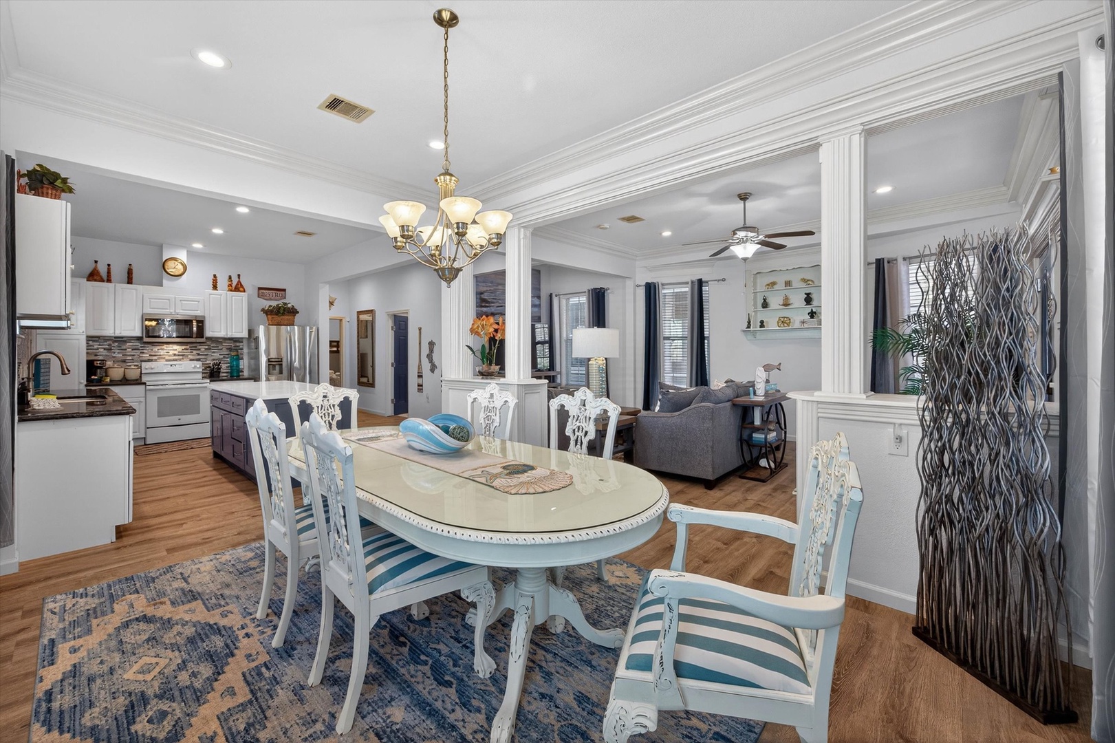 Your elegant dining space flows seamlessly into the kitchen and living areas, perfect for memorable meals and conversations together.