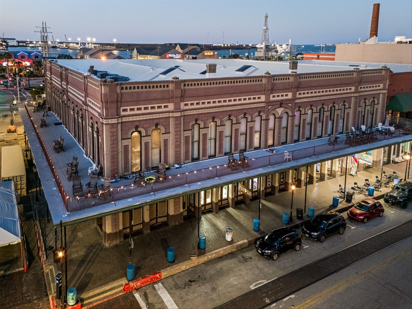 Historic downtown brick building with balcony and arched windows.