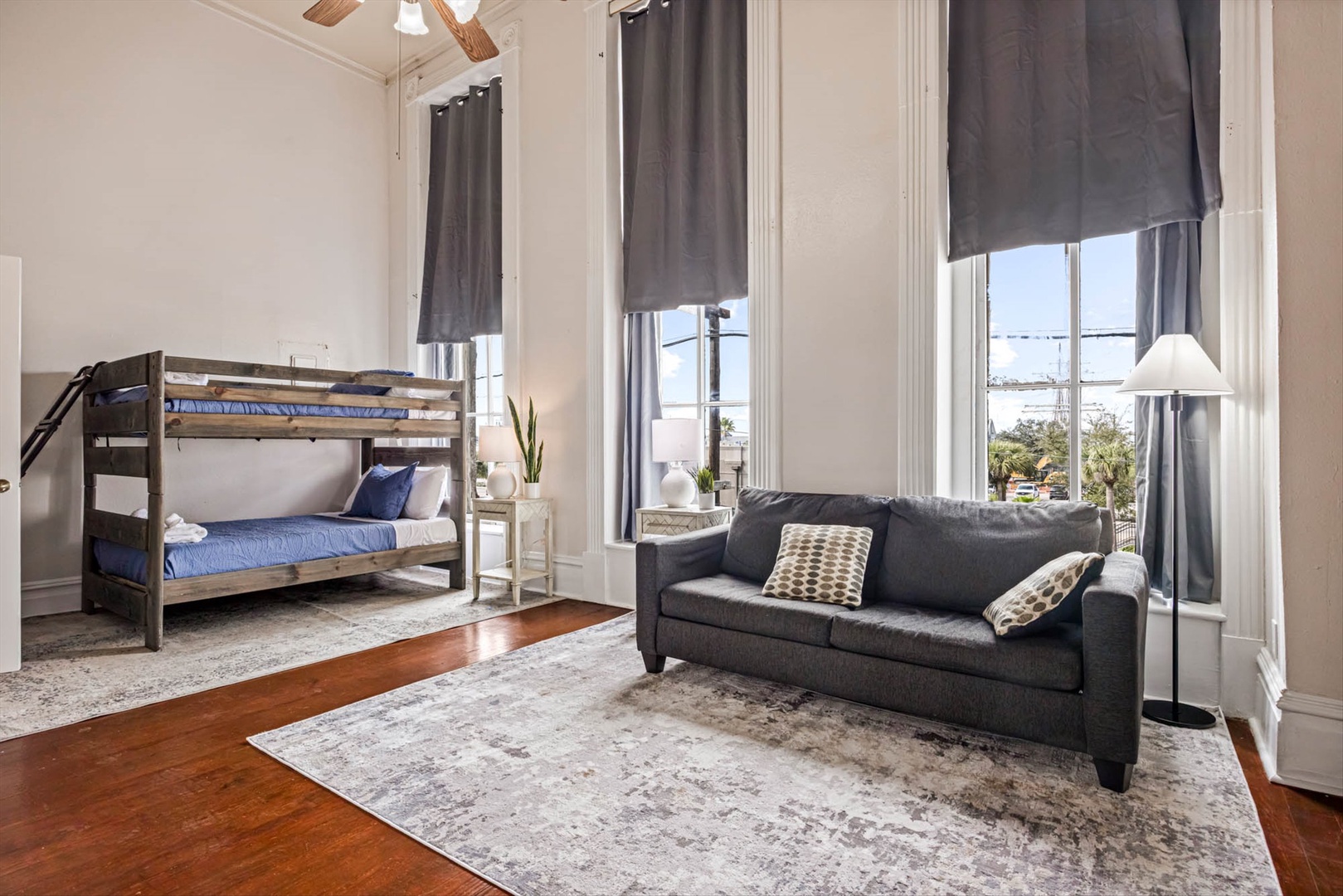 Family-friendly room with sofa, bunk beds, and city views.