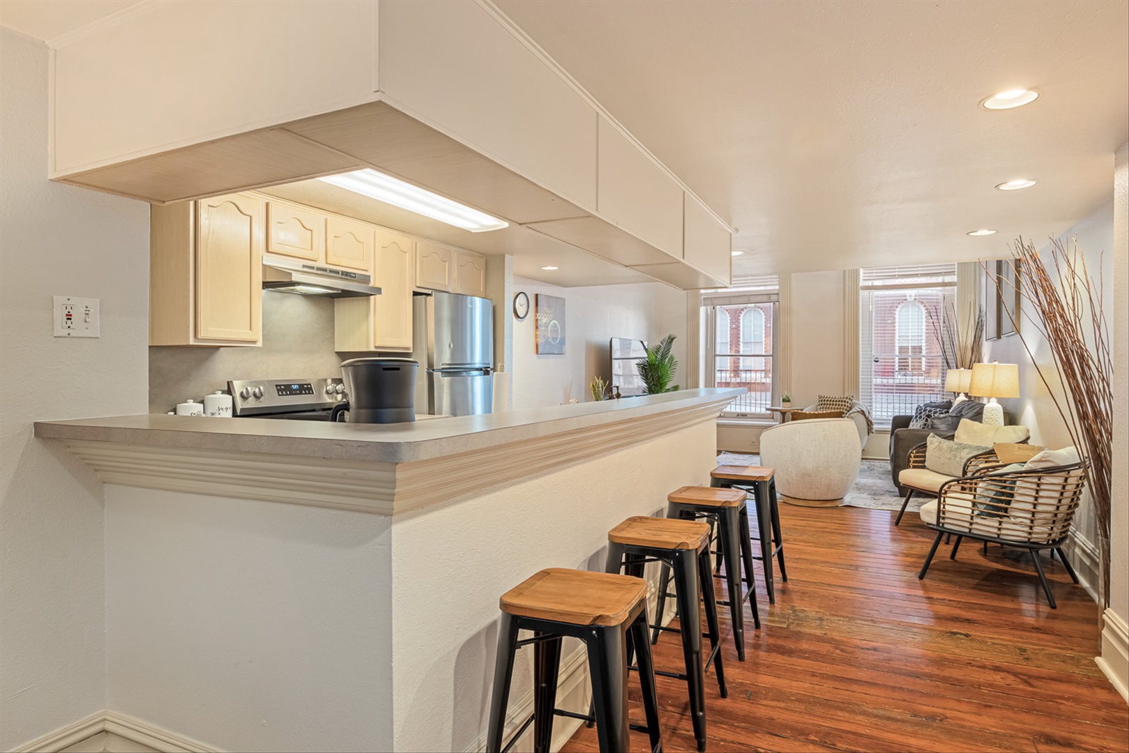 Bright open space with kitchen island and bar seating.