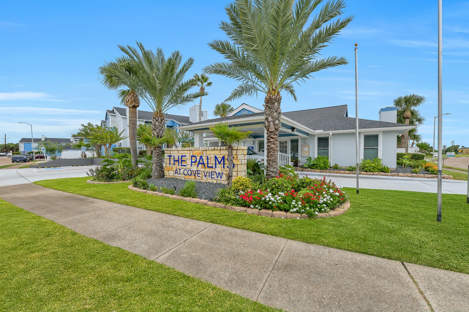 Beautifully landscaped entrance to The Palms at Cove View