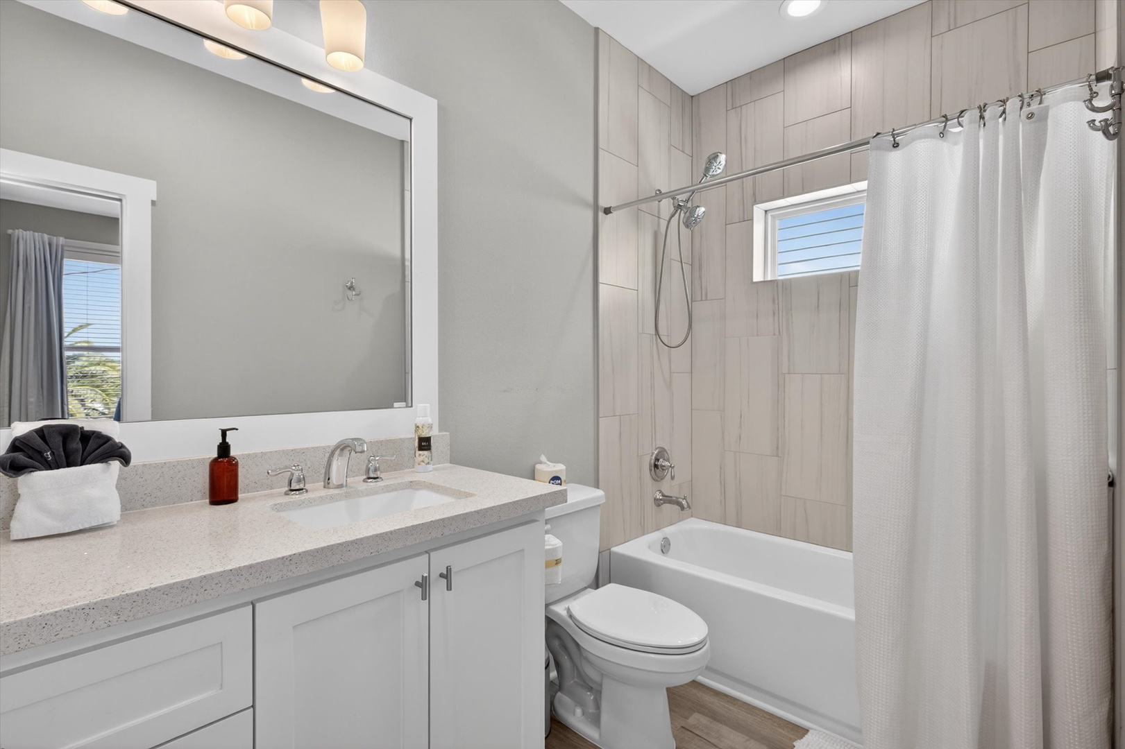 Modern bathroom with soft lighting and tub-shower.