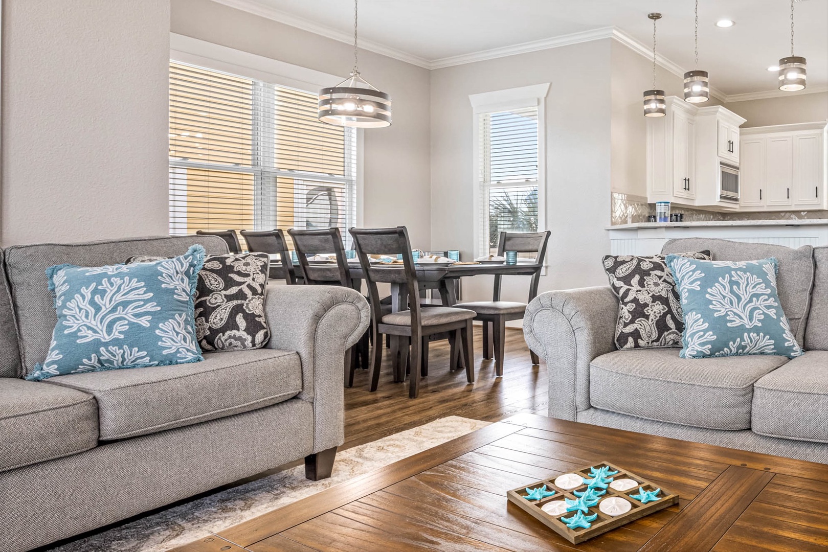 Coastal-inspired living area with gray sofas and open flow.