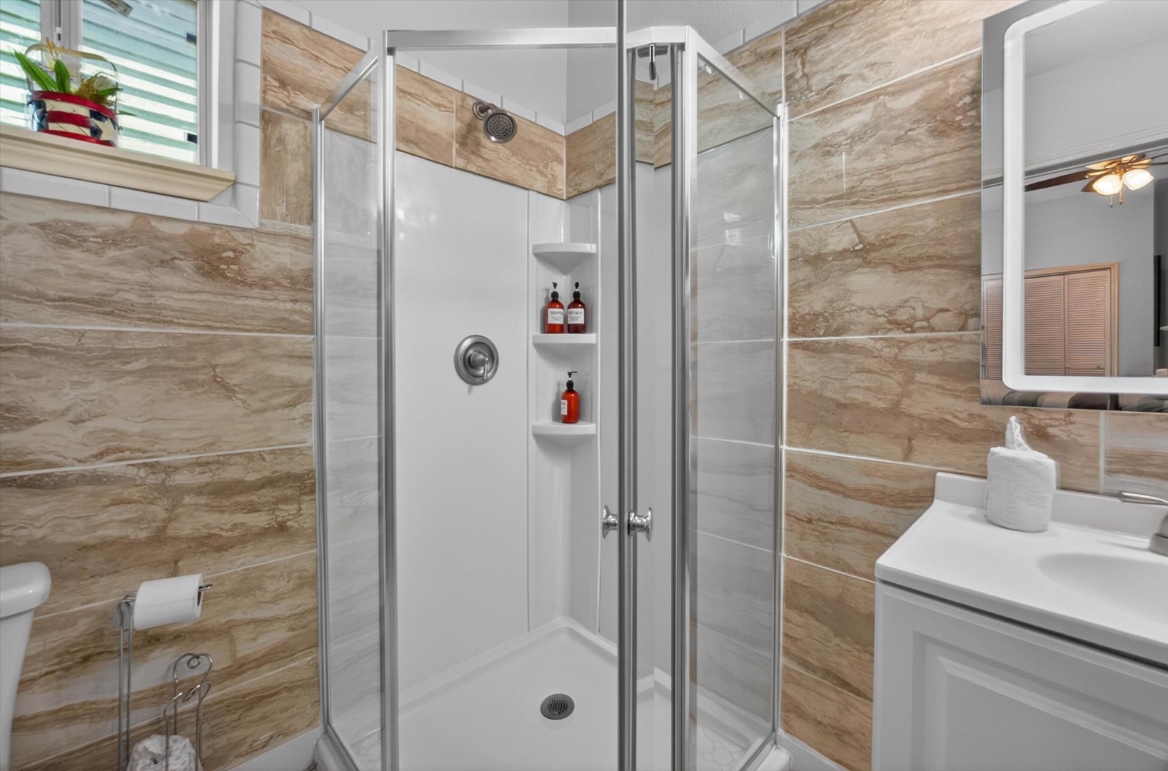 Refresh in your stylish ensuite bathroom featuring a spacious glass-enclosed shower with premium toiletries and sleek modern fixtures.