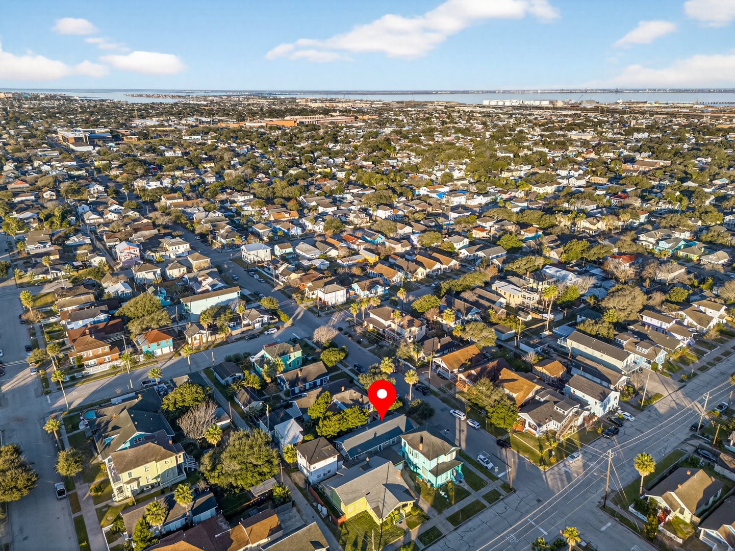 Aerial view showcasing a charming residential neighborhood with tree-lined streets and easy access to nearby waterfront areas.