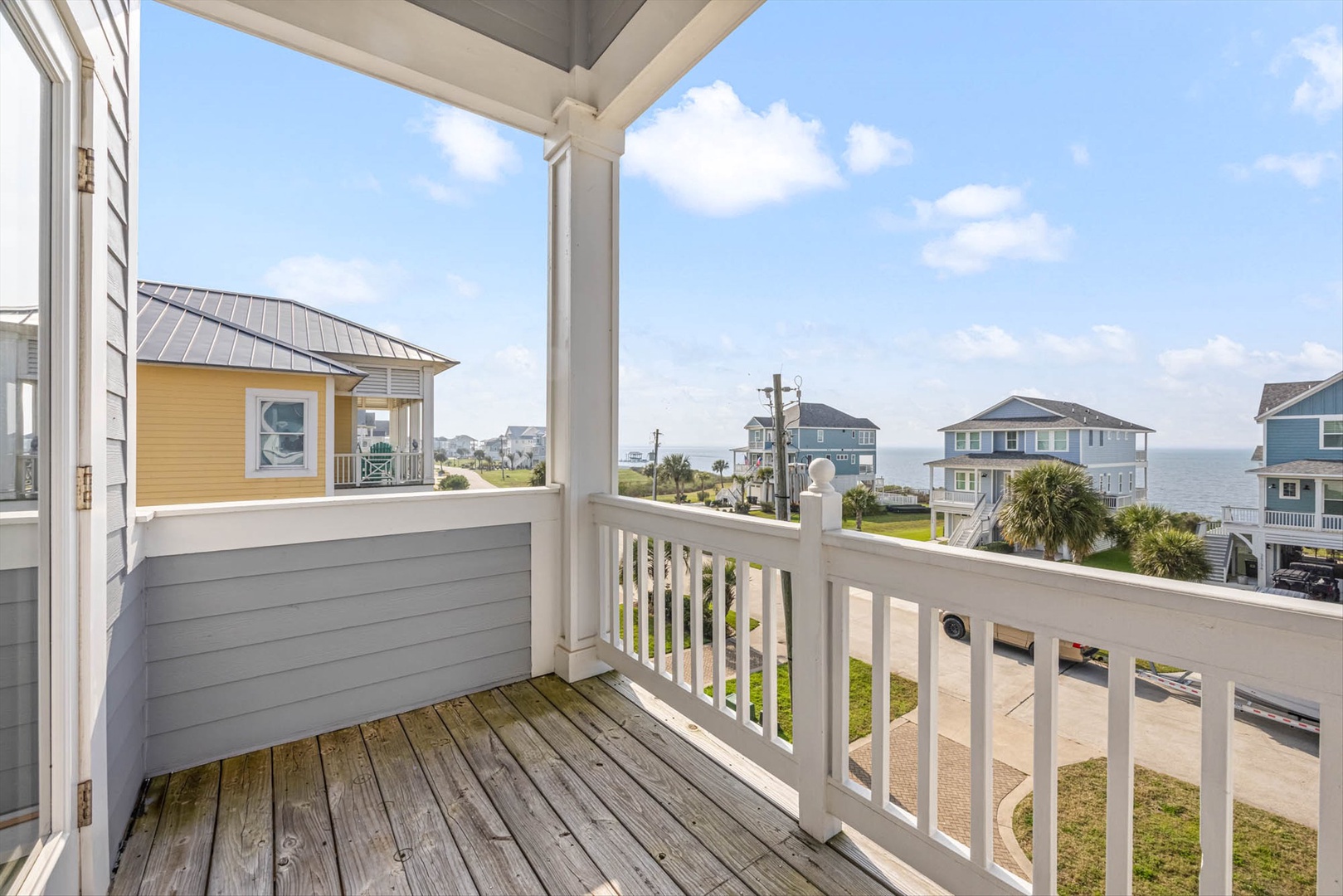 Top front balcony with sunset and bay views.