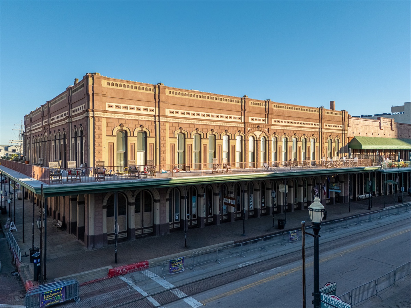Historic sandstone building with elegant arched windows and covered walkways in the heart of the Strand.