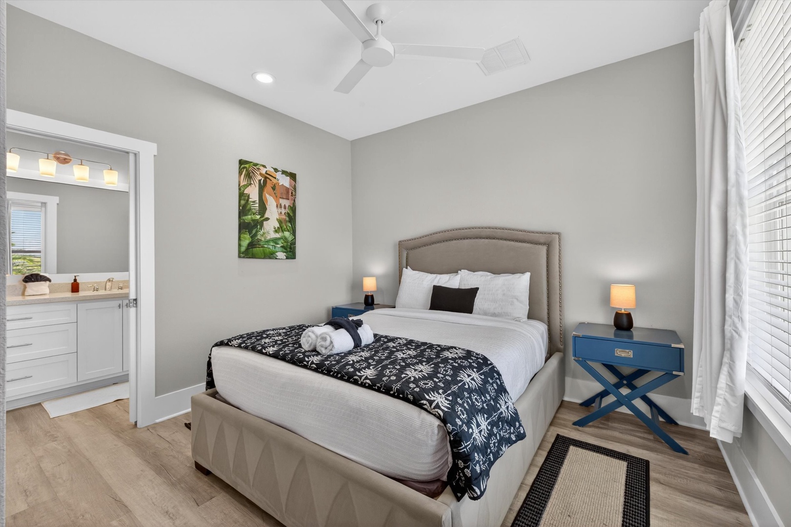 King bedroom retreat with ensuite and coastal artwork.