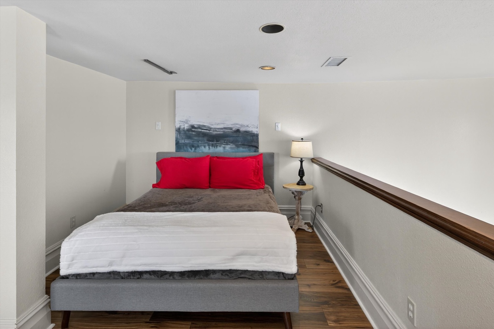 Peaceful retreat with soft linens and abstract artwork. Open to the downstairs area.