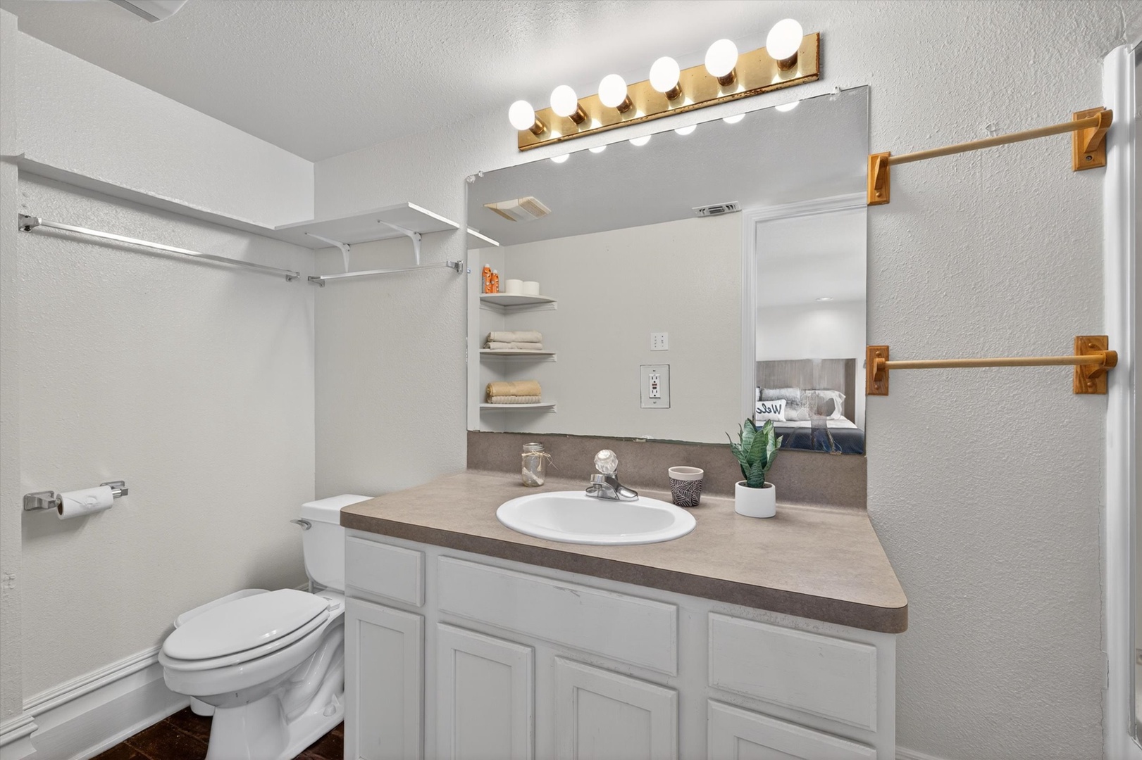 Bright bathroom with shower and vanity lighting.
