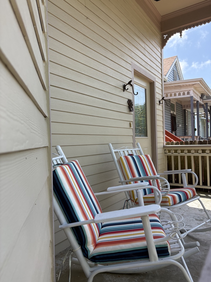 Relax on a deck with colorful chairs and city views.