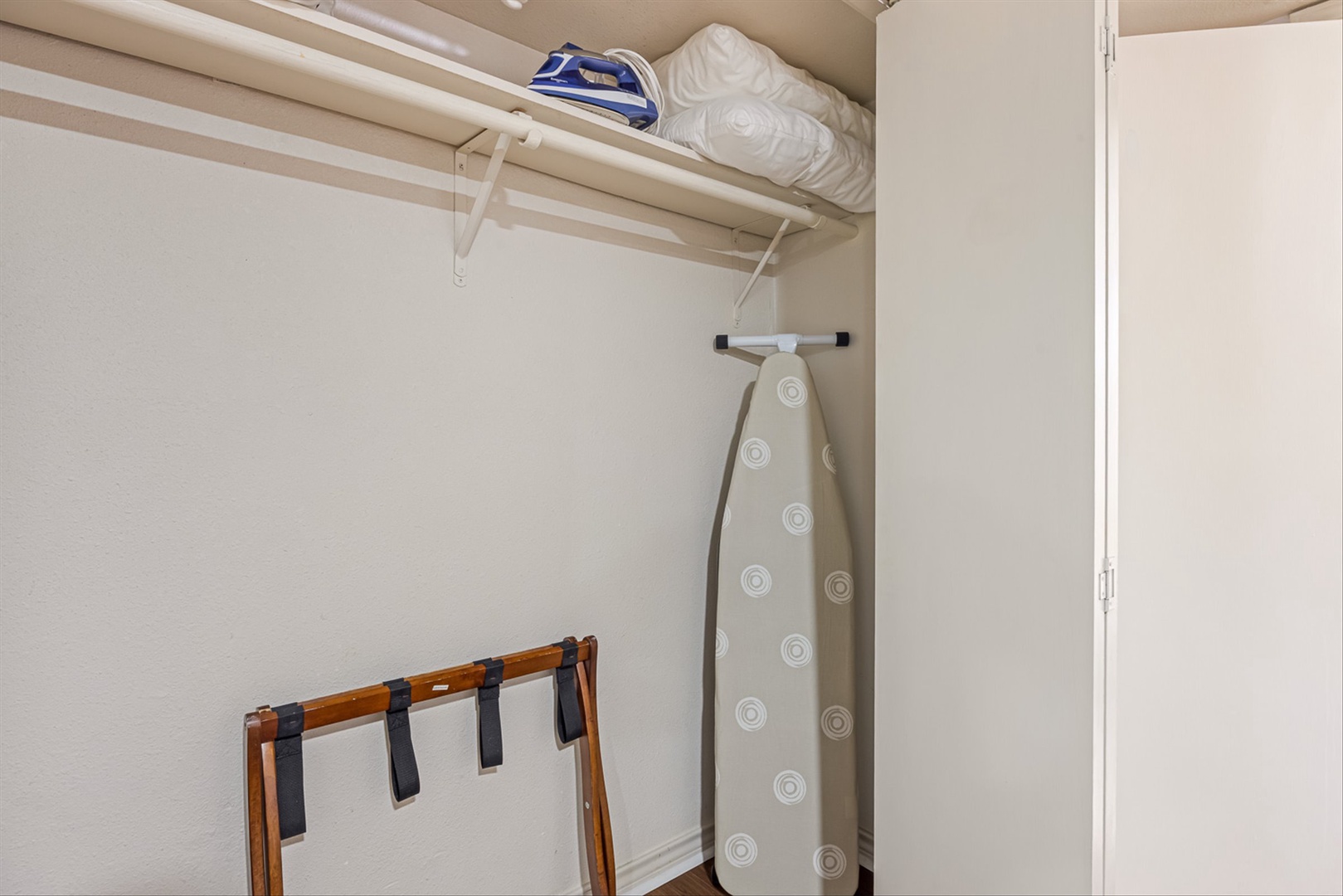Laundry space with storage and iron to keep clothes crisp.
