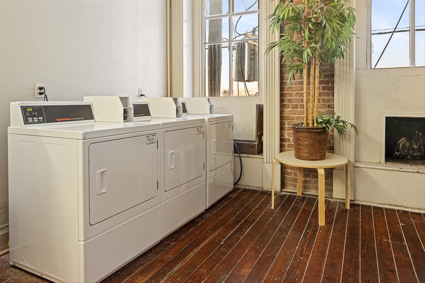 Bright laundry space with modern washers and dryers.