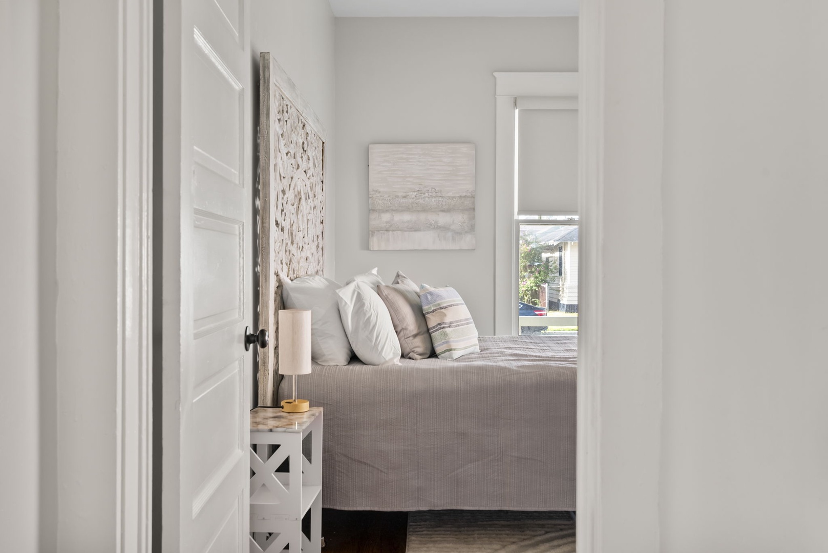 Bedroom with neutral tones and artwork for a peaceful stay.