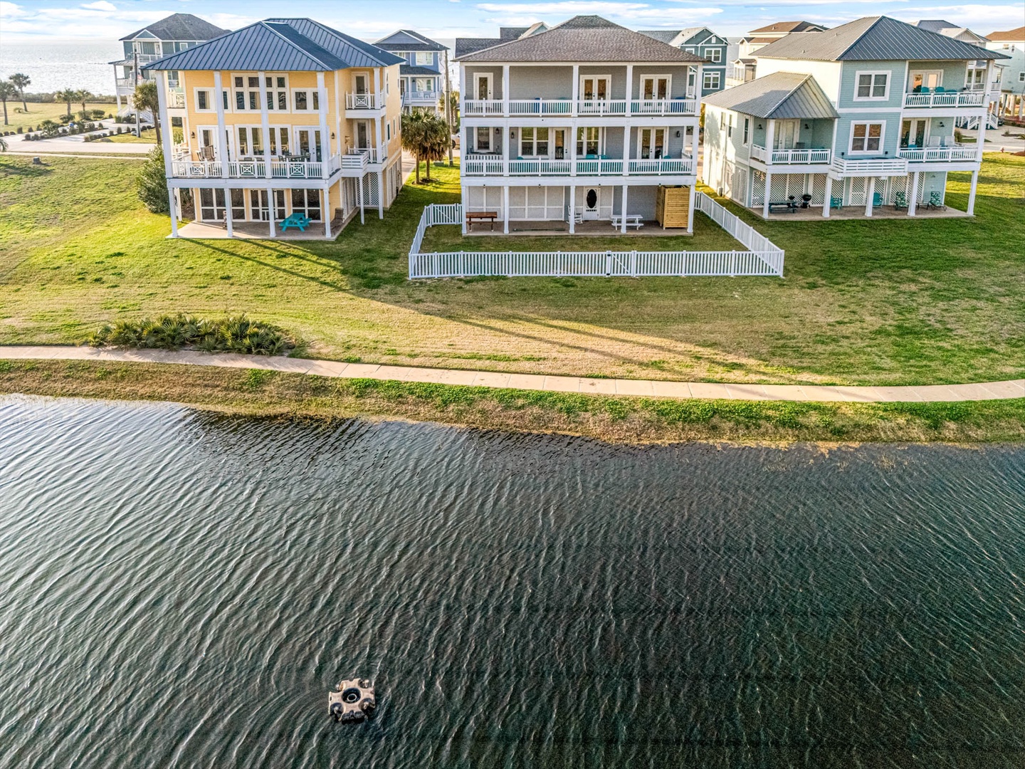 Waterfront vacation homes along a peaceful coastal canal.