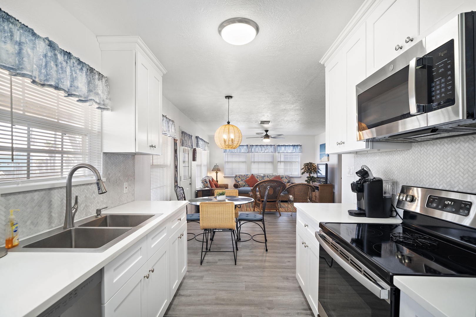 Step into your bright, fully-equipped kitchen where morning coffee and home-cooked meals await. The open layout flows seamlessly into your cozy living space, perfect for relaxing after exploring.