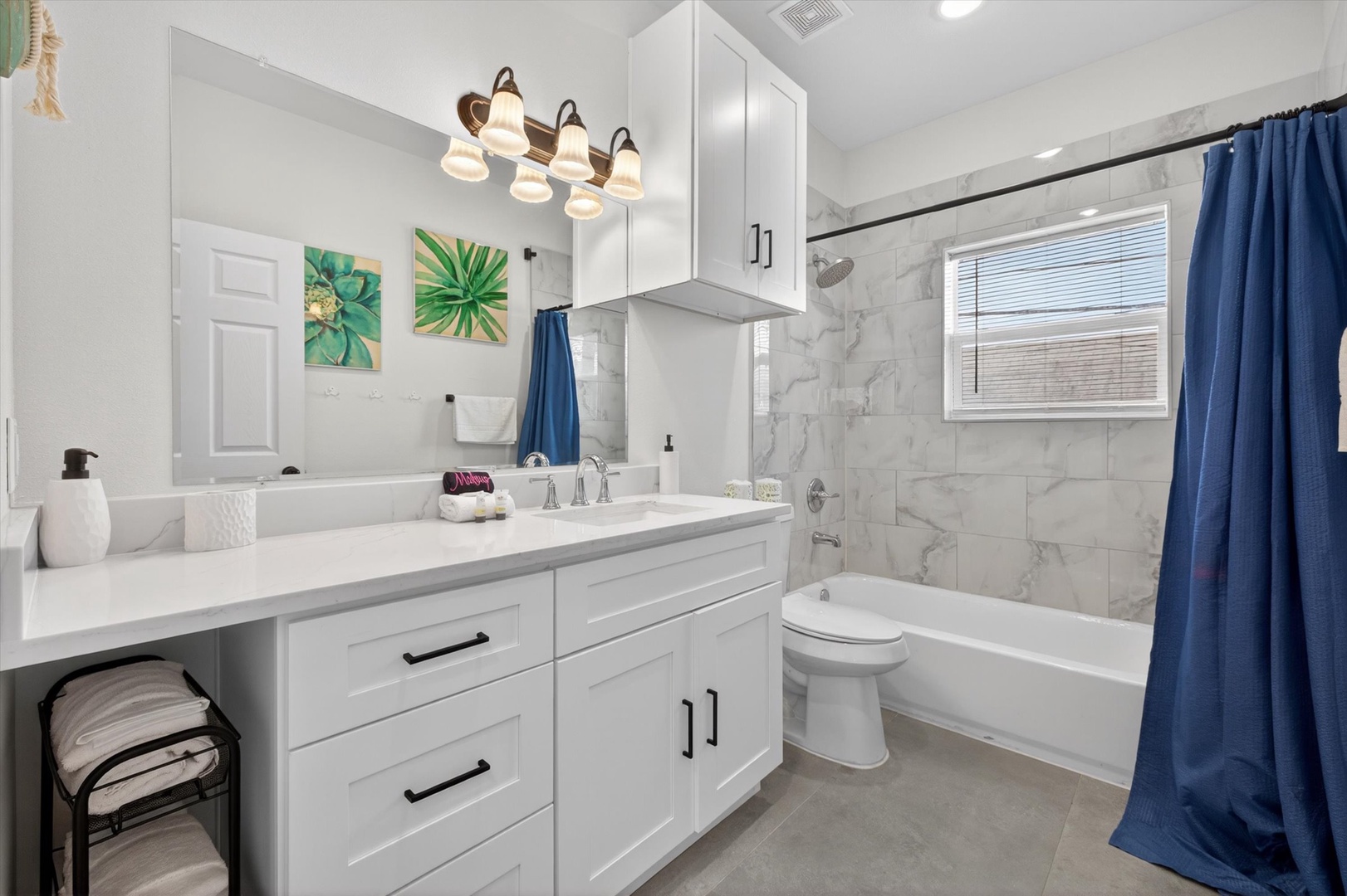 Private bath with marble tile and spa-style fixtures.