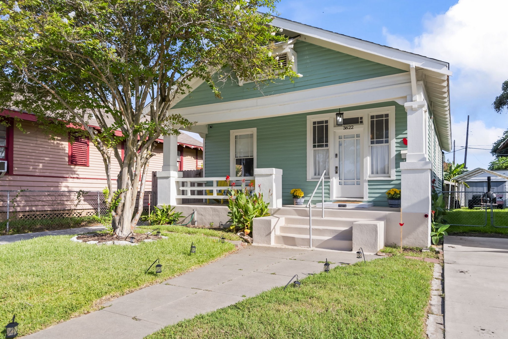 Mint-green cottage in a quiet residential neighborhood.