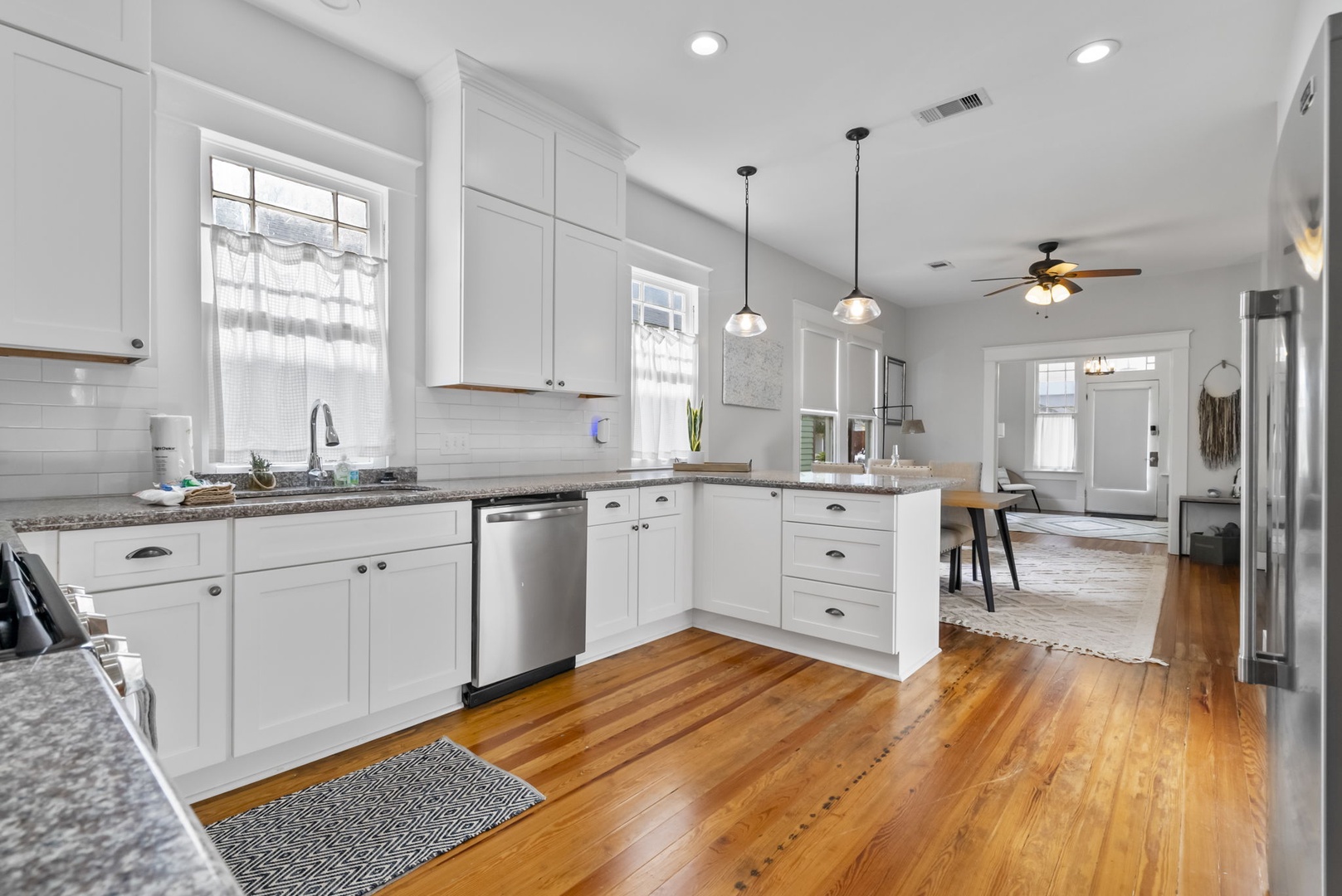Recently remodeled kitchen with granite, stainless appliances, and wood floors.