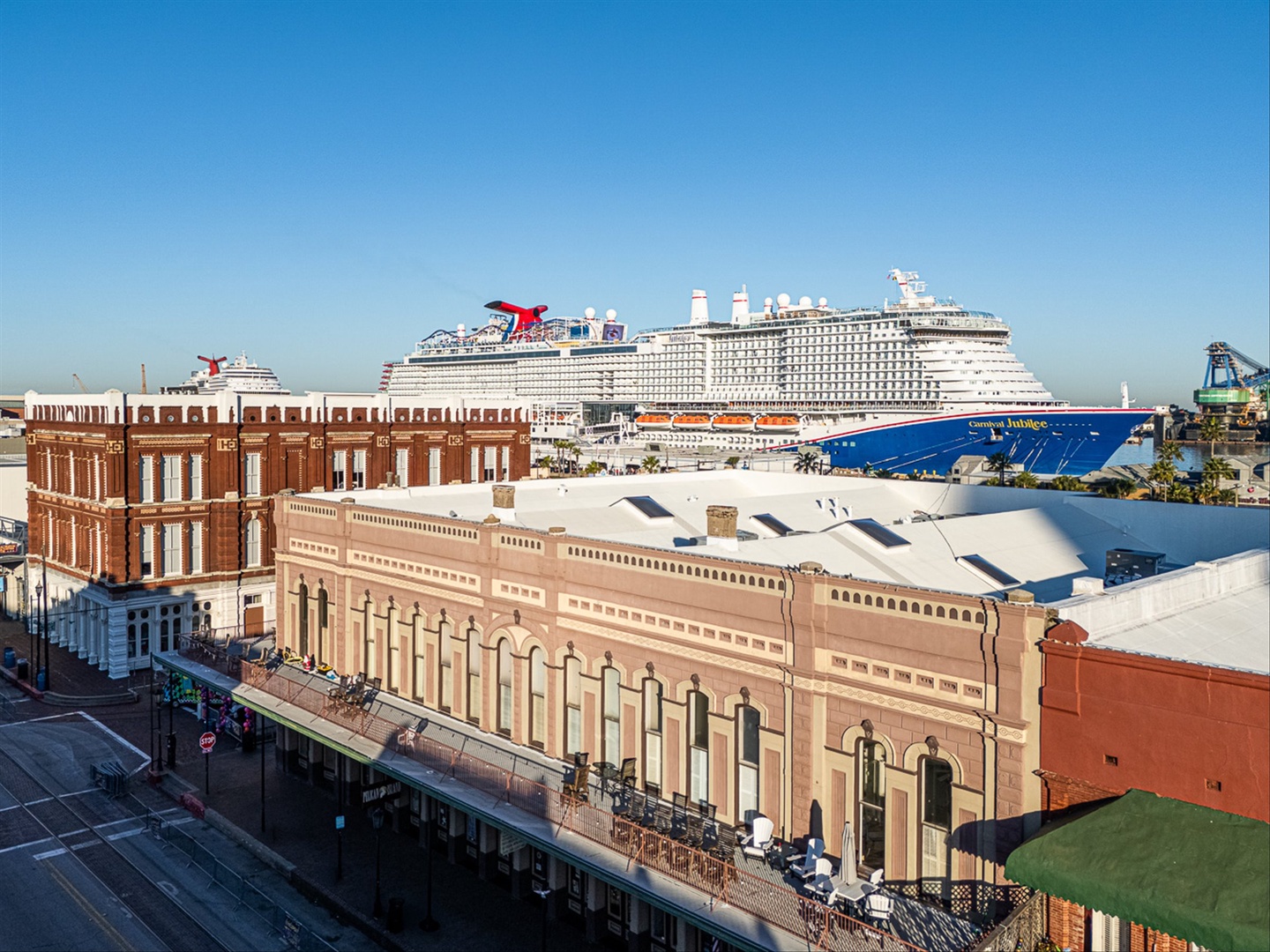 You can see the historic harbor district with cruise ships docked from your balcony.