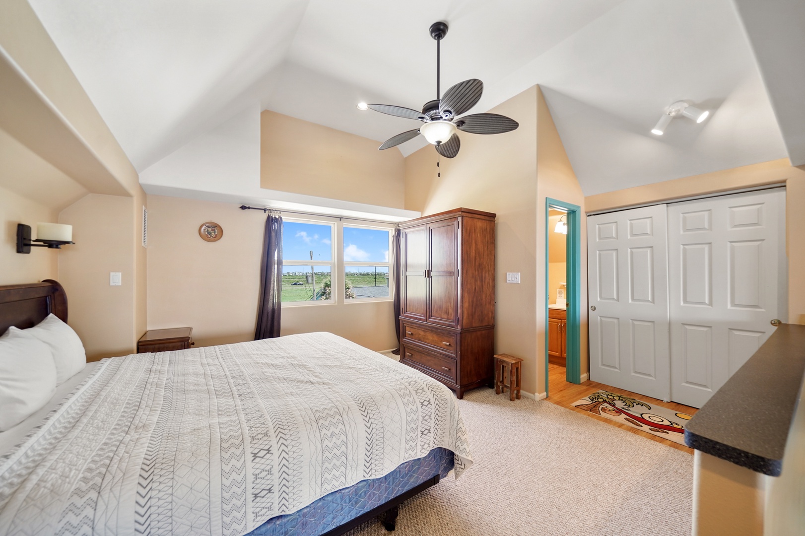Comfortable bedroom with vaulted ceilings