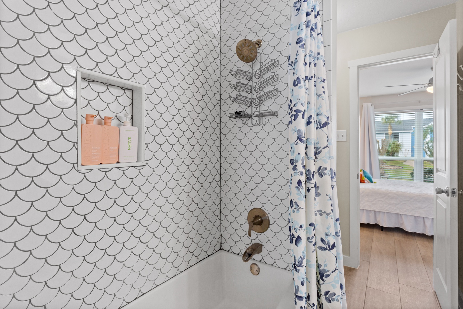 Coastal bath with scalloped tile & brass accents