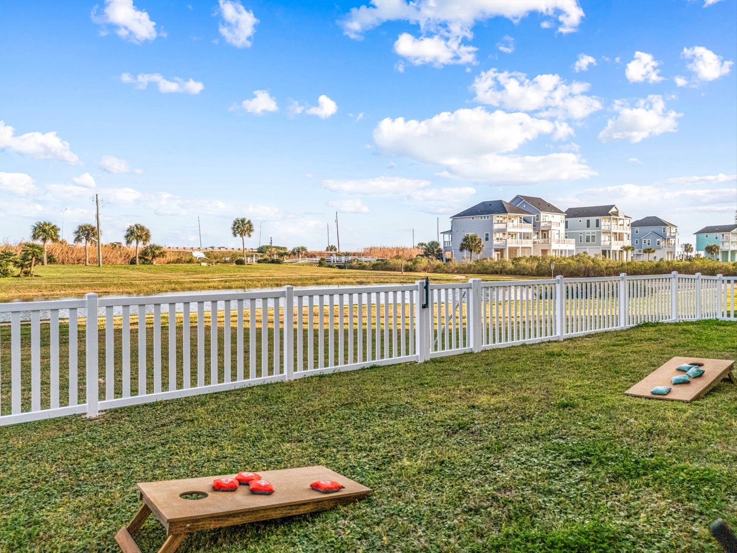 Coastal community with beach houses and lawn cornhole.