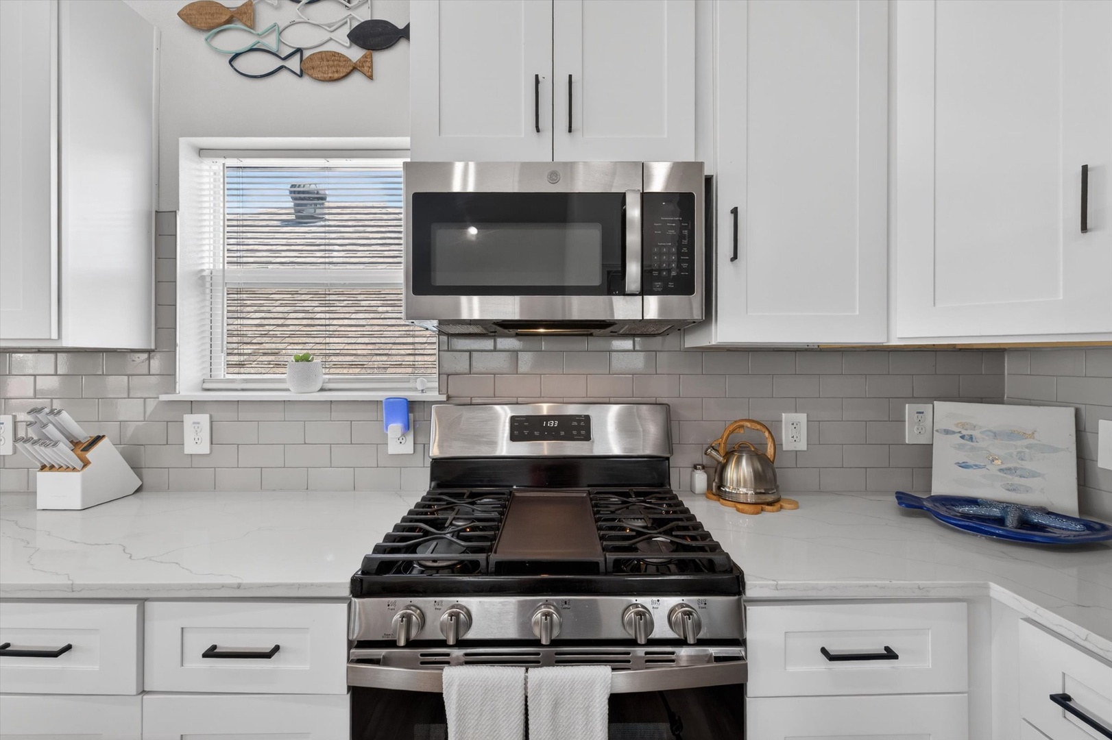 Well-equipped kitchen with modern stainless appliances.