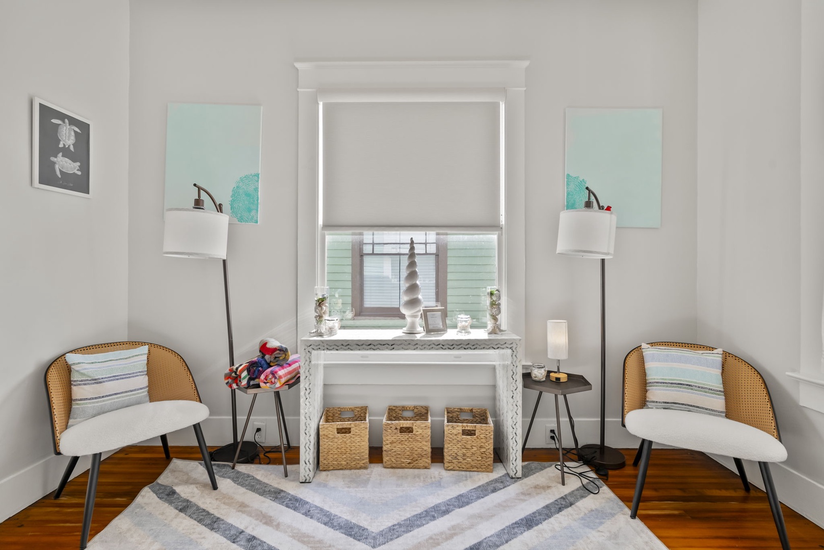 Reading nook with cozy chairs, soft lighting, and décor.