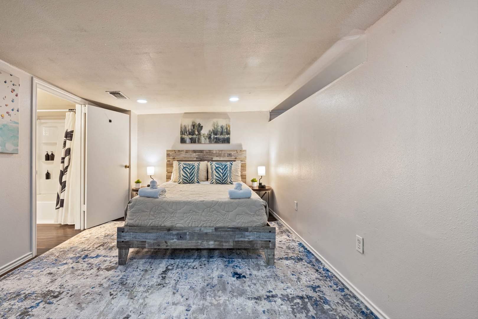 Plush bedding in a serene retreat with coastal blues and wood.