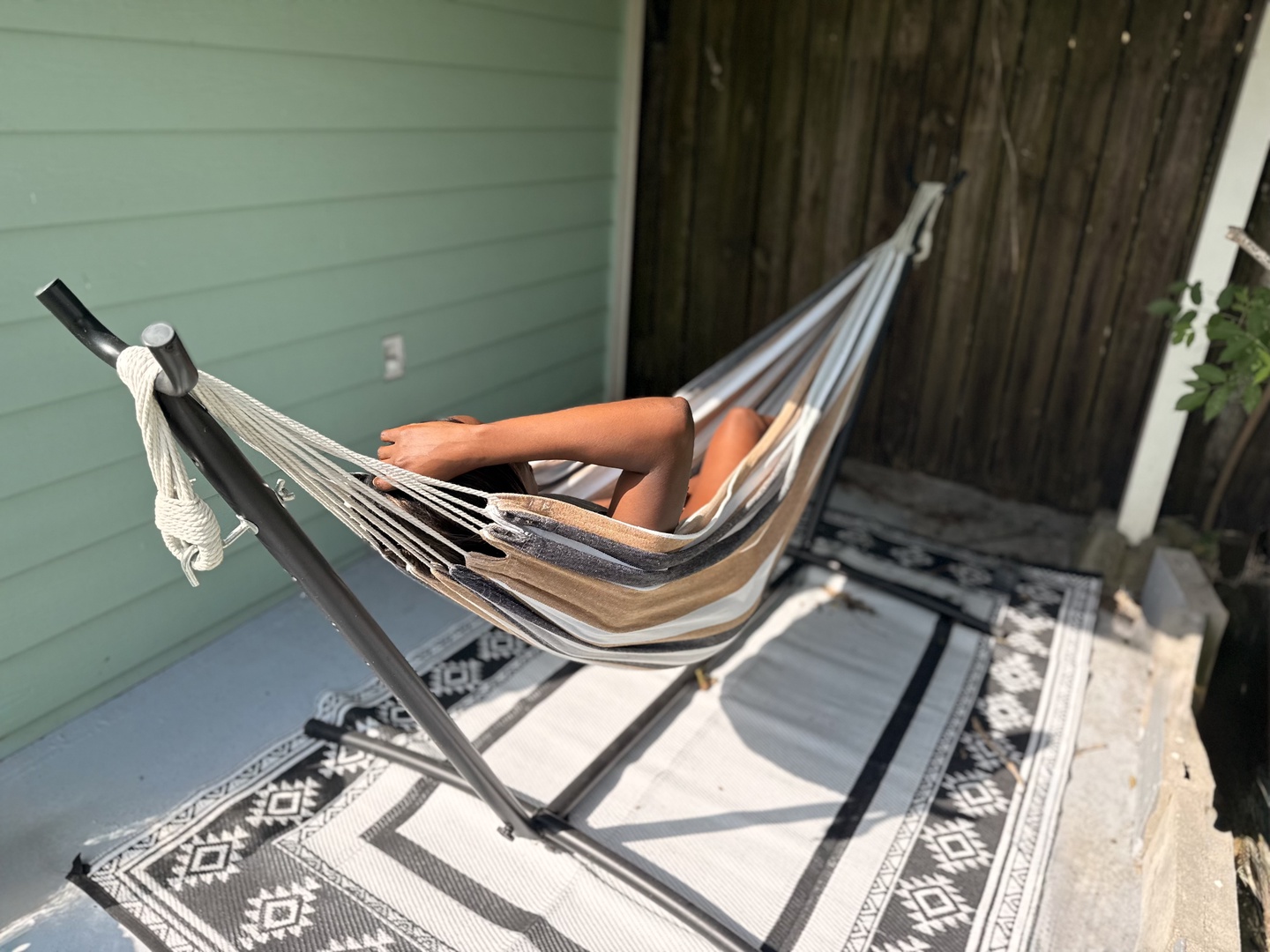 Drift off in your own cozy hammock on the private patio, where soft afternoon sun and peaceful surroundings make relaxation effortless.