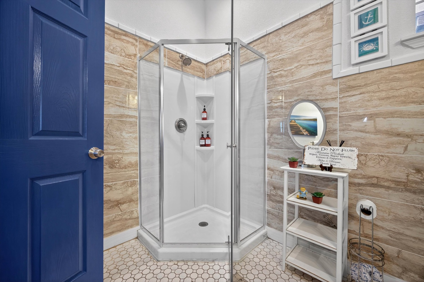 Step into your modern glass shower with premium toiletries and coastal-inspired decor—your personal spa retreat awaits.
