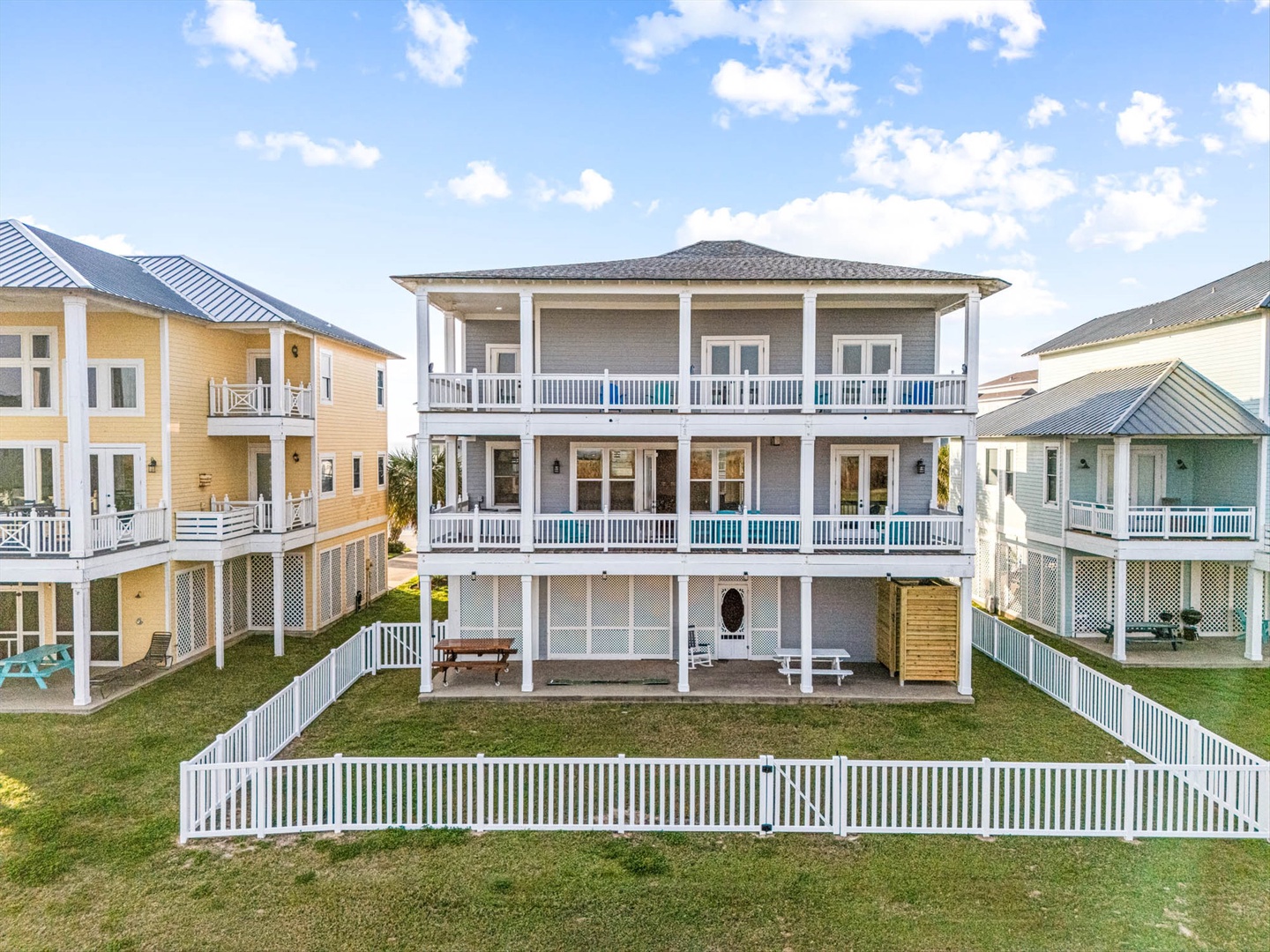 Back of the house with covered porches and private fenced yard.