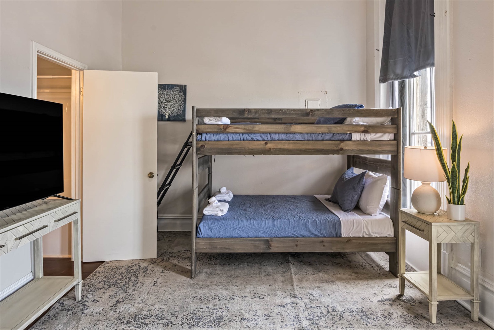 Cozy family room with sofa, bunks, and city views.