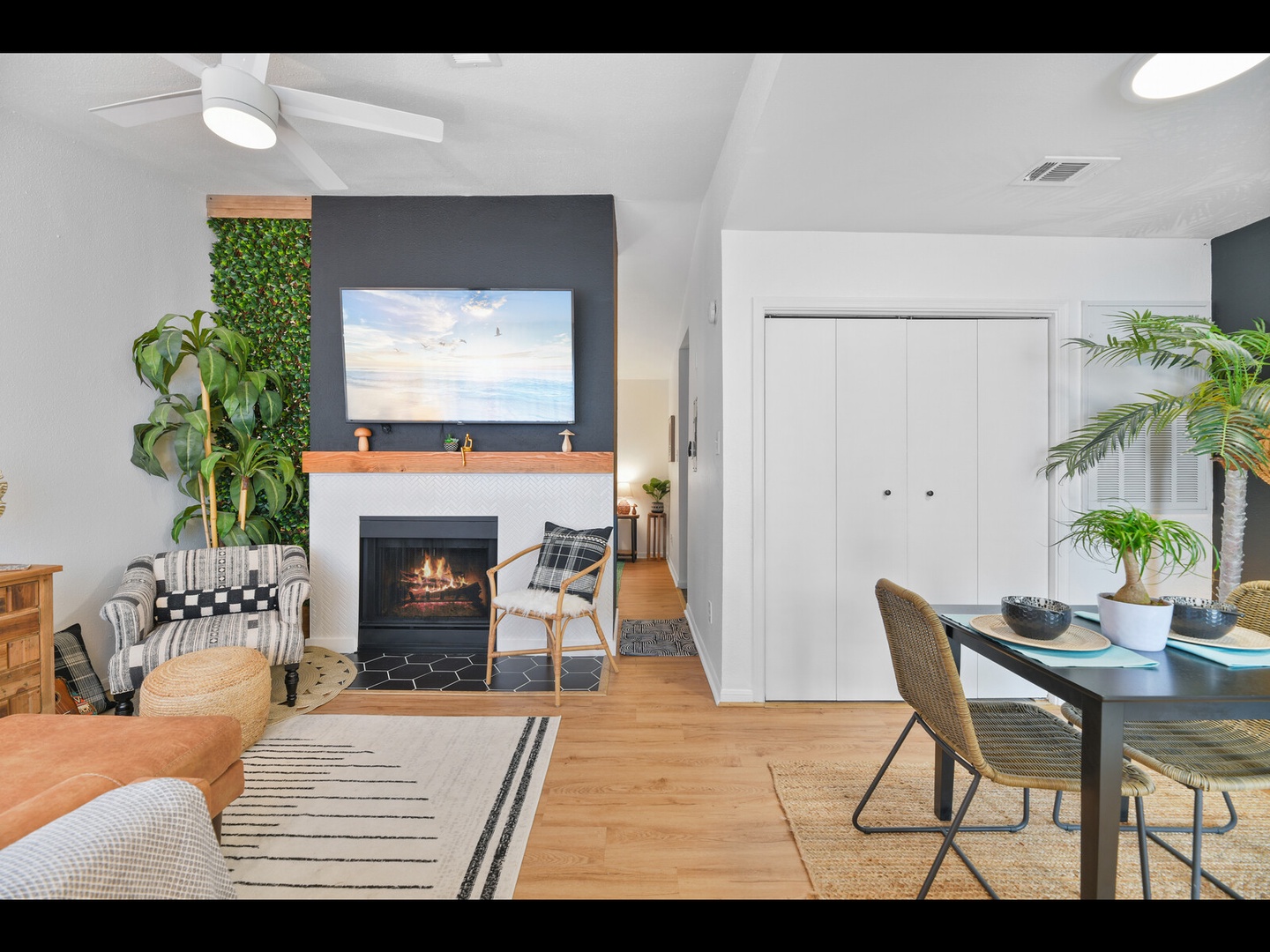 Coastal living space with fireplace & dining
