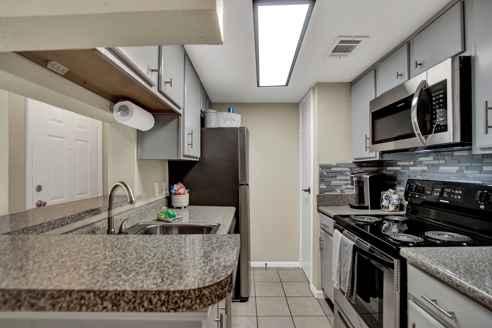 Modern kitchen with granite counters and sleek cabinetry