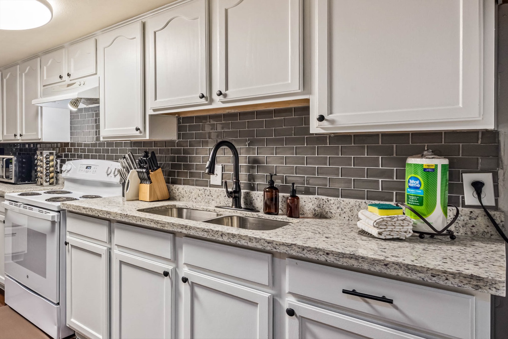 Granite counters, white cabinets, fully stocked.
