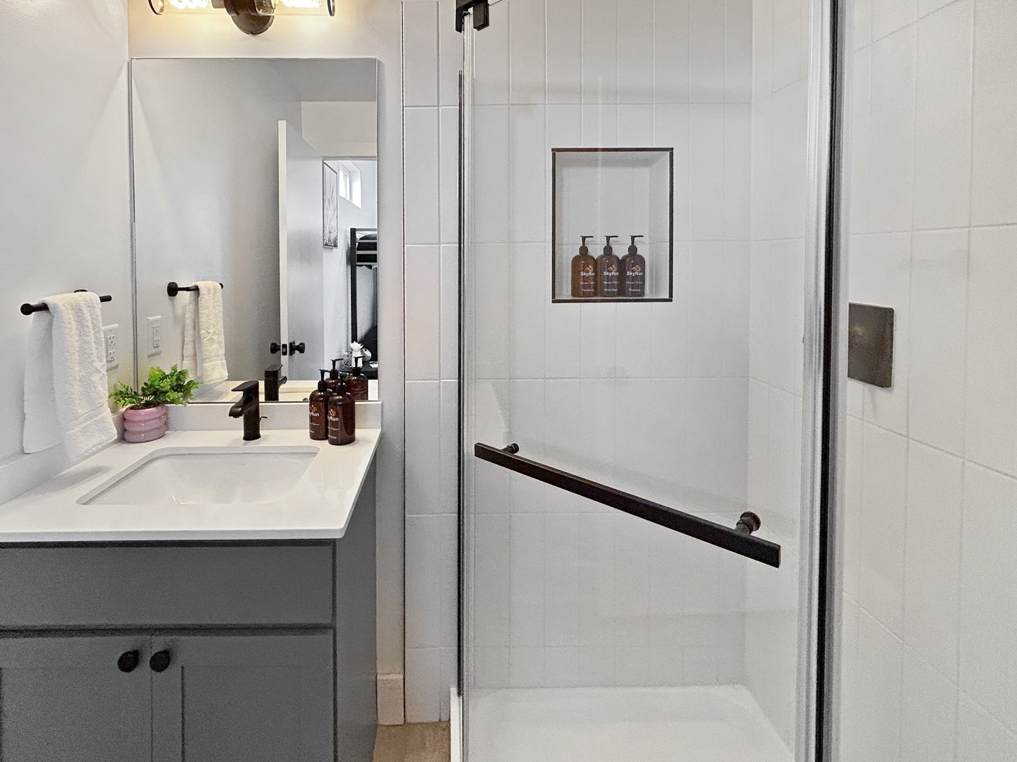 Step into your spa-like bathroom retreat with a spacious walk-in shower, elegant vanity, and thoughtful amenities ready for your comfort.