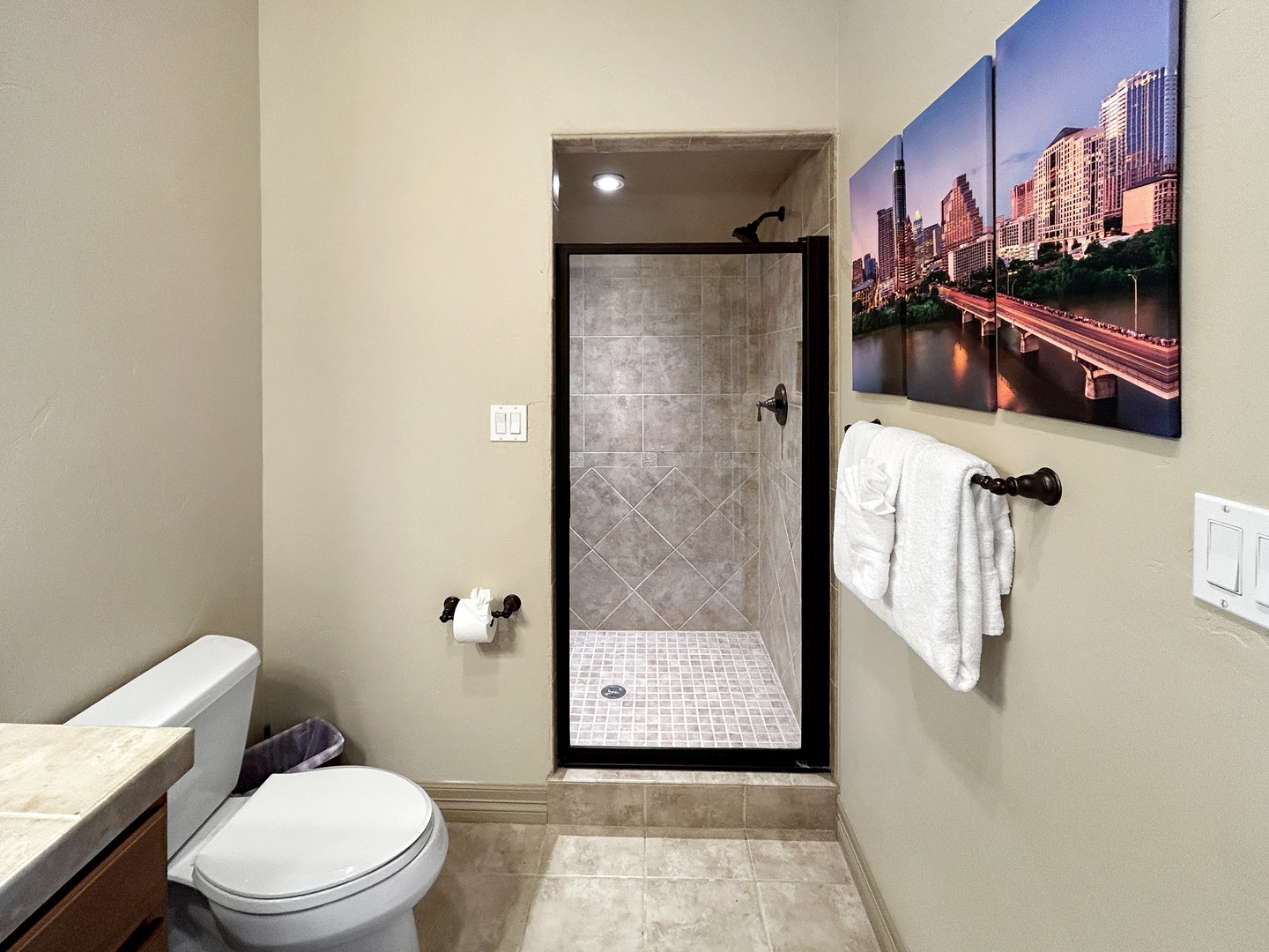 Step into your private bathroom featuring a spacious walk-in shower, and fresh towels waiting for your arrival.