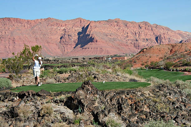Desert golf course with dramatic red rock cliffs creating a stunning backdrop for your game.