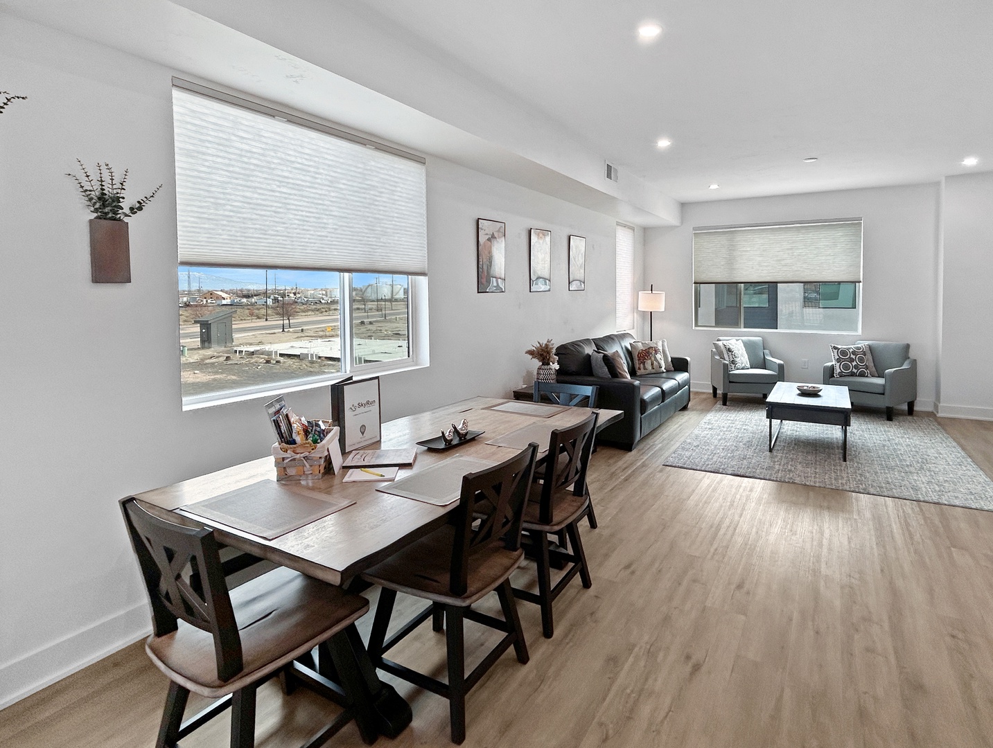 Unwind in your spacious open-concept living space with comfortable seating, perfect lighting, and stunning panoramic views from large windows.