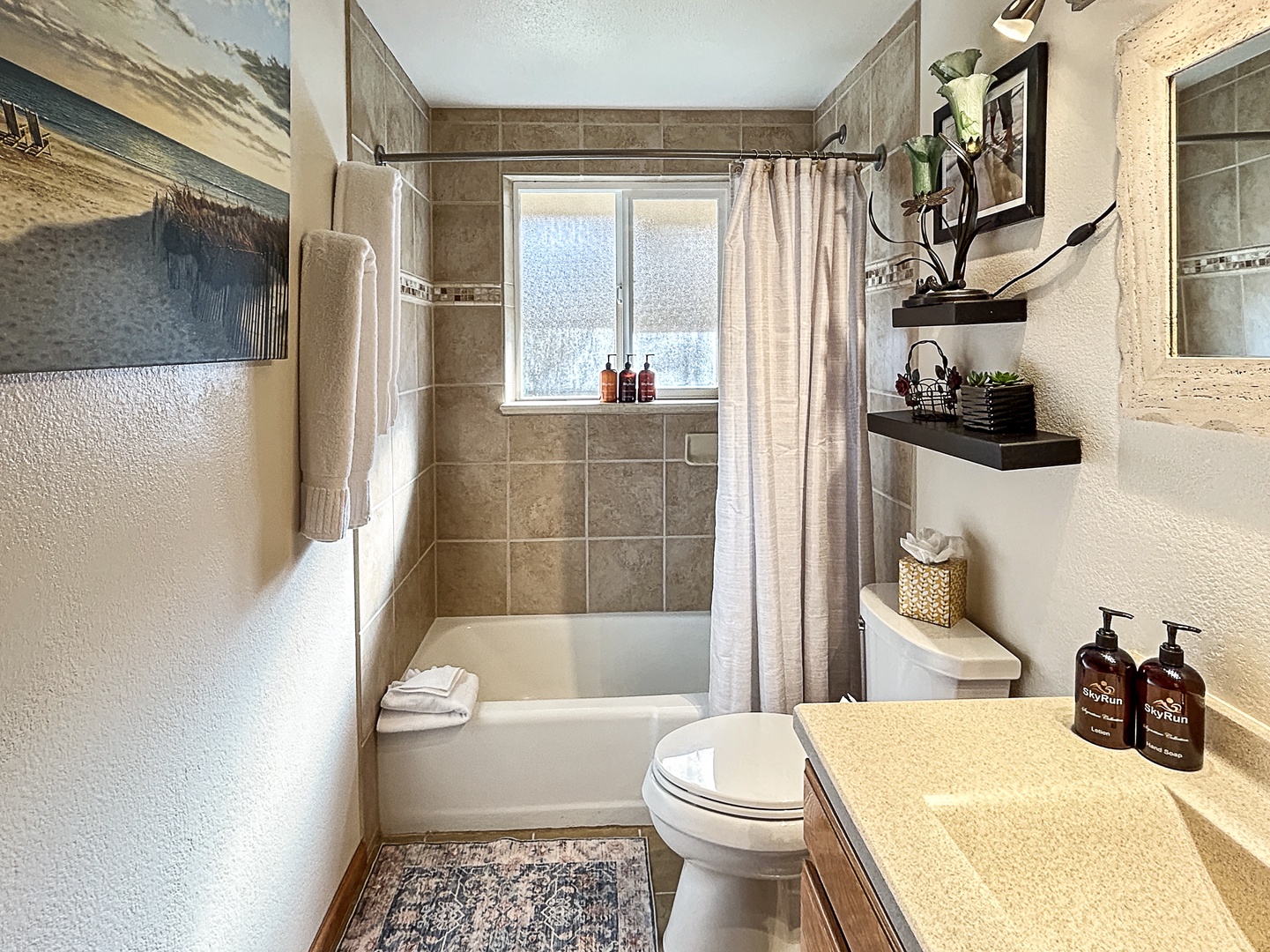 Elegant bath with spacious tub, natural light, and luxe touches.