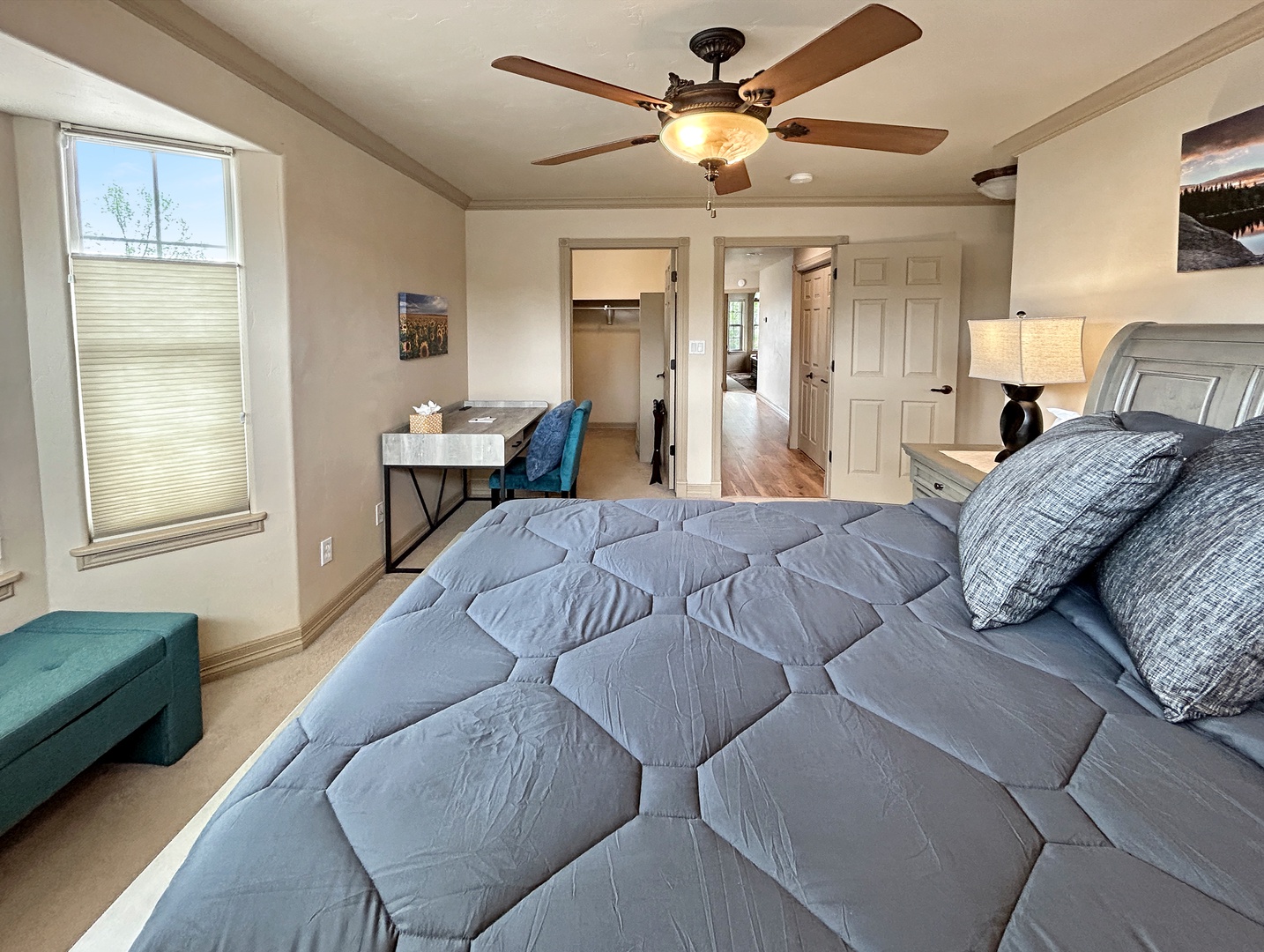 Drift off to sleep in this comfortable bedroom with plush bedding, your own workspace, and gentle ceiling fan breeze.