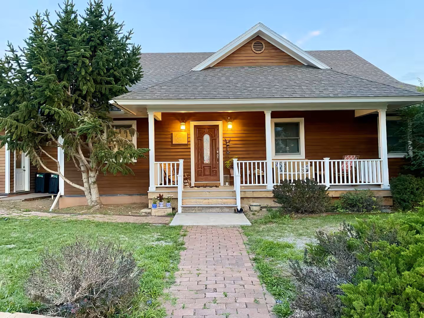 A charming home featuring classic gabled architecture and mature landscaping.