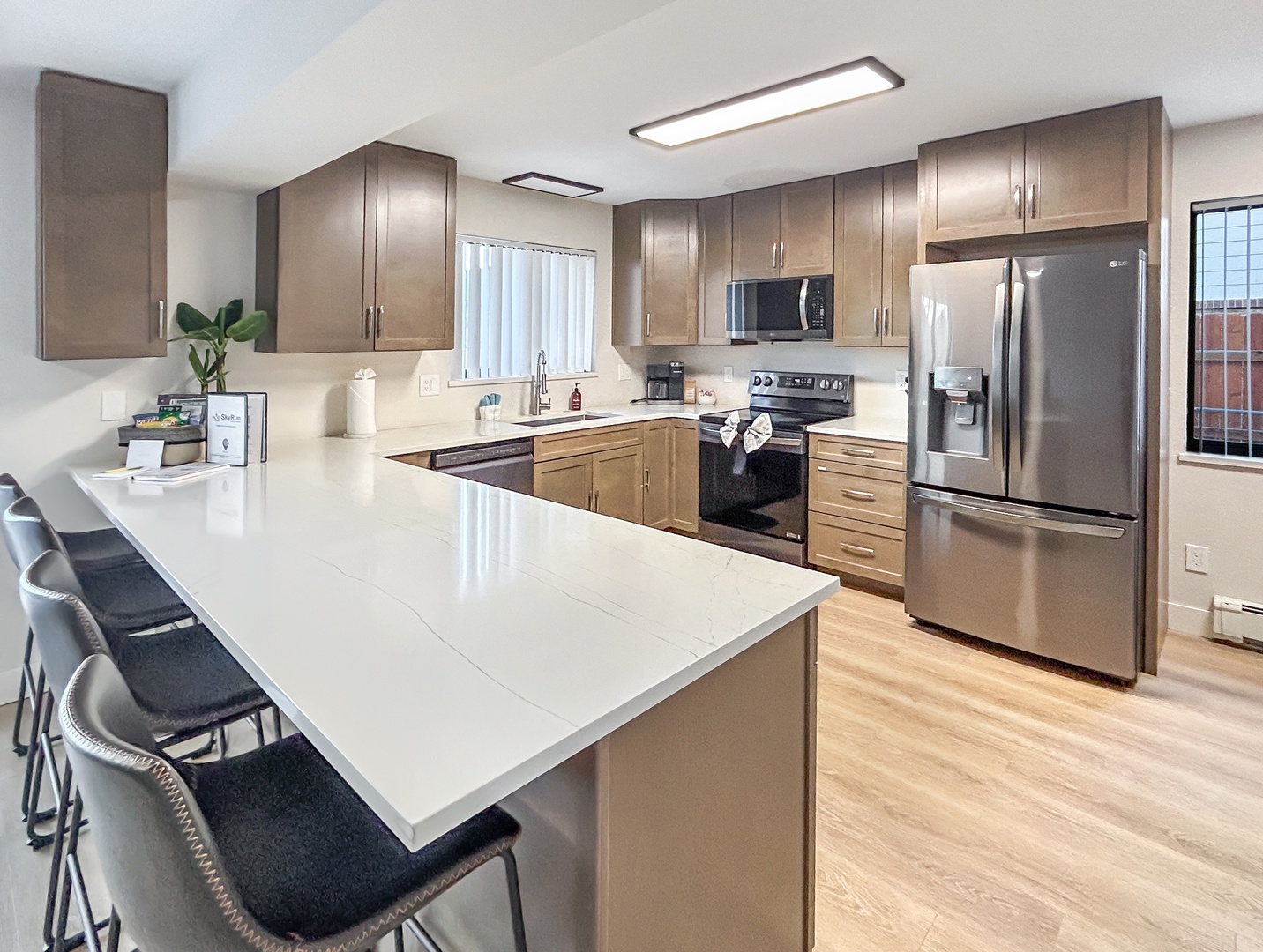 Your fully equipped kitchen awaits with stainless appliances, and breakfast bar seating for memorable meals together.