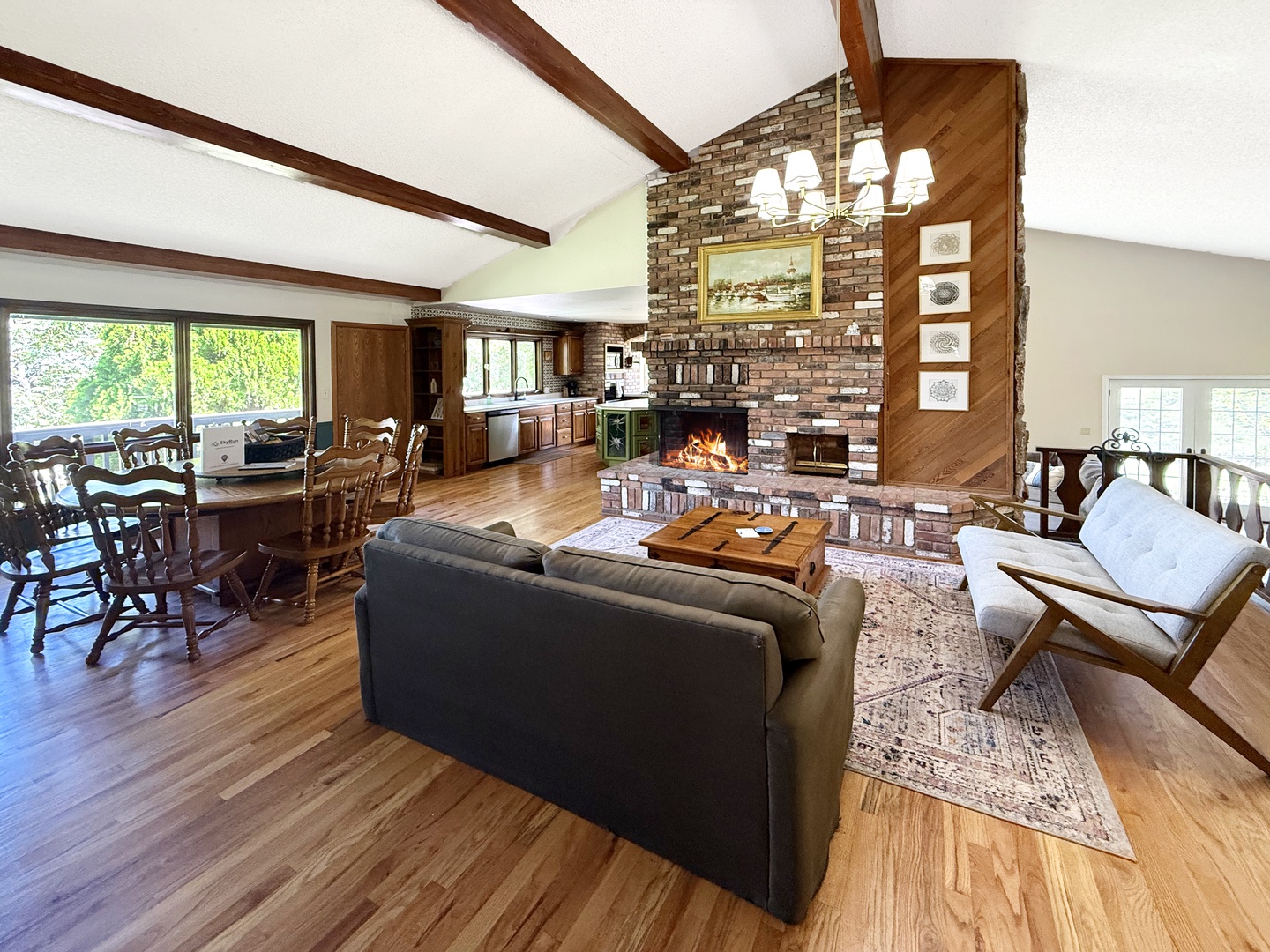 Unwind in this inviting open-concept retreat with warm wood floors, exposed beams, and a brick wood burning fireplace.