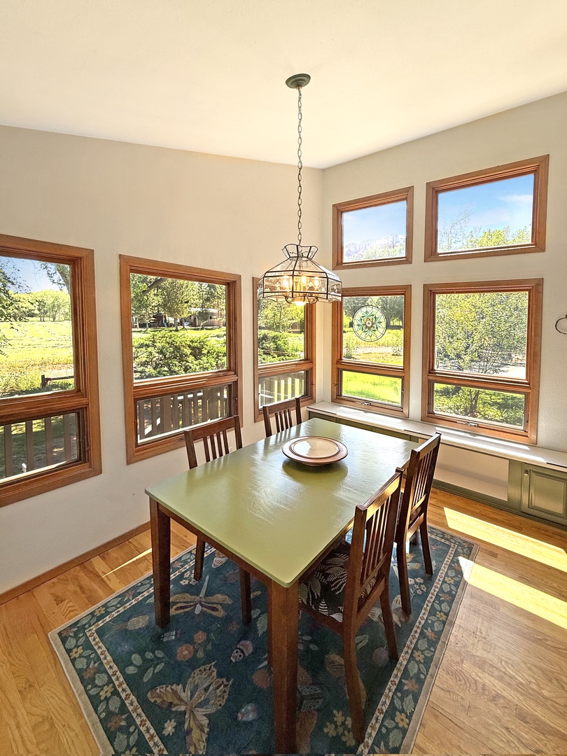 Gather around this inviting table with countryside views framing the windows.