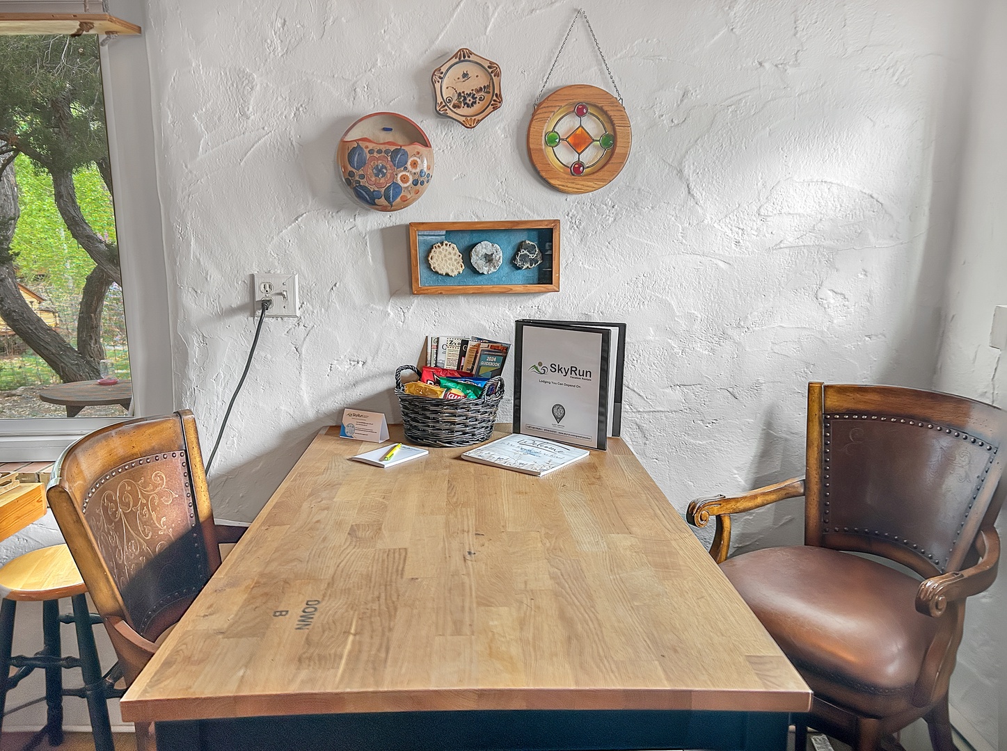 Your perfect workspace awaits with rustic wooden table, vintage leather chairs, and charming wall art creating an inspiring atmosphere for productive days.