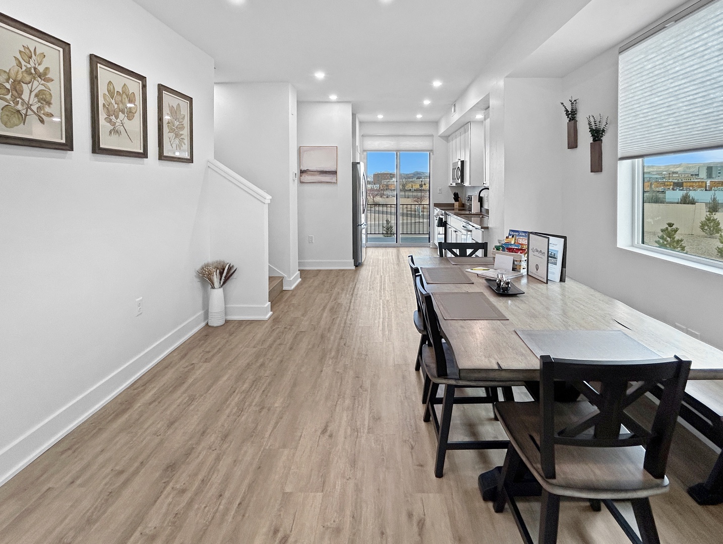 Your stylish dining area flows seamlessly into the modern kitchen, where natural light fills the space and city views create a perfect backdrop for memorable meals.